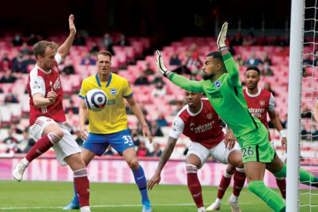 هولدينغ (يسار) في مواجهة برايتون في نهاية الموسم الماضي (أ.ب)