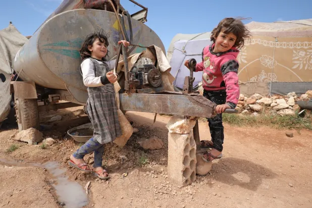 Children play at Al-Tehh camp for Syrians in Idlib, Syria, 07 May 2022. (EPA)