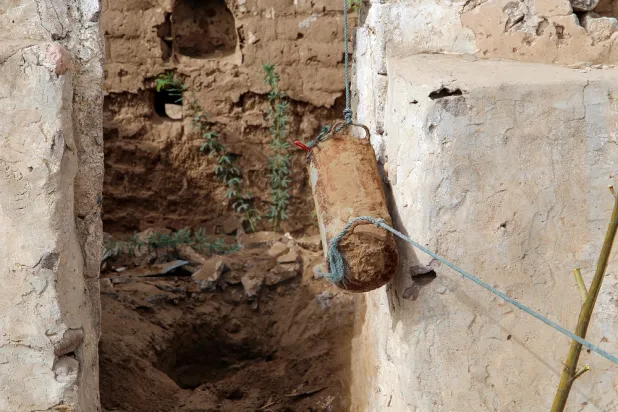 An explosive devices is removed by members of Yemen's legitimate government forces search for a house in the village of Hays in Yemen's western province of Hodeidah, On May 23, 2022. (AFP)
