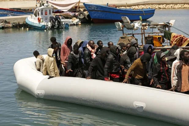 Migrants heading to Europe are brought back to port after being intercepted in the Mediterranean Sea by the Libyan coast guard, in Gasr Garabulli, northwestern Libya, Monday, May 23 2022. (AP)