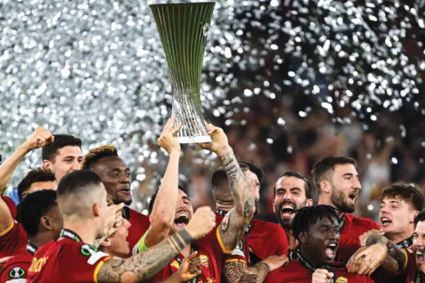 لاعبو روما يحتفلون بأول كأس لمسابقة «كونفرنس ليغ» (أ.ف.ب)