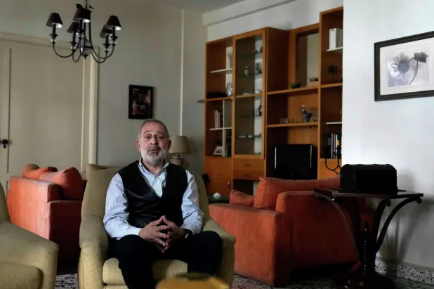 Ramy Finge, a dentist spent two years braving tear gas and rubber bullets during anti-government protests, is one of 13 independent newcomers who won a seat in the latest parliamentary elections, speaks during an interview with The Associated Press, at his home in Tripoli, north Lebanon, Tuesday, May 24, 2022. Hussein Malla/AP