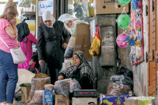 سوريون يتسوقون في إحدى أسواق دمشق القديمة أول من أمس (أ.ف.ب)