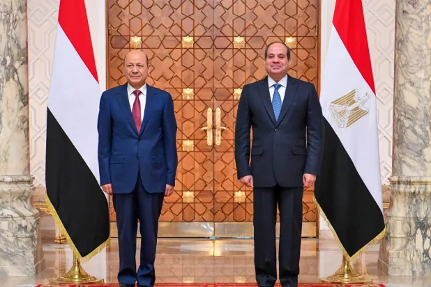 A handout picture released by the Egyptian Presidency's official Facebook page on June 11, 2022 shows Egyptian President Abdel Fattah al-Sisi (R) posing for a picture with Rashad al-Alimi, head of Yemen's Presidential Leadership Council, ahead of their meeting in the capital Cairo. (Egyptian Presidency/AFP)
