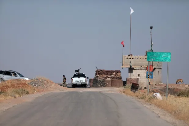 Security forces block an entrance to the village of Humayra, where US coalition forces conducted an overnight airborne operation, in the Ghandoura district in the north of Syria's Aleppo province on June 16, 2022. (AFP)