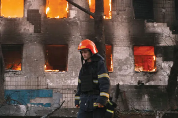 أحد عناصر الدفاع المدني لإخماد النيران في موقع طاله القصف الروسي في ميكولايف جنوب أوكرانيا أمس (أ.ب)