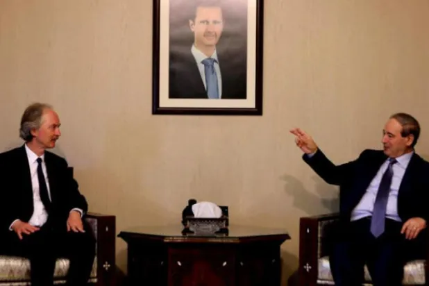 Syrian Foreign Minister Faisal Meqdad meets with UN envoy Geir Pedersen in Damascus on May 22. (AFP)