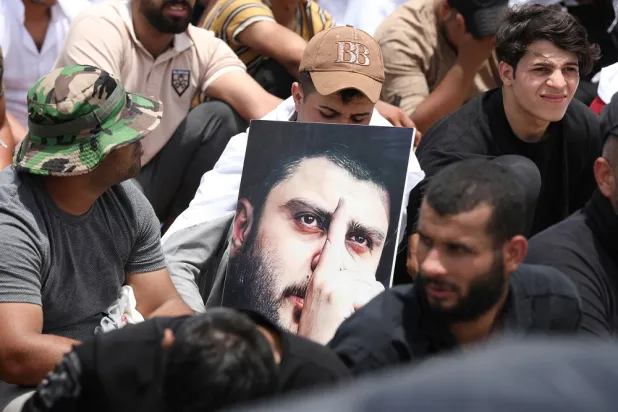 Supporters of cleric Moqtada al-Sadr gather for mass Friday prayer in the Sadr City district of Baghdad, Iraq, July 15, 2022. (Reuters)