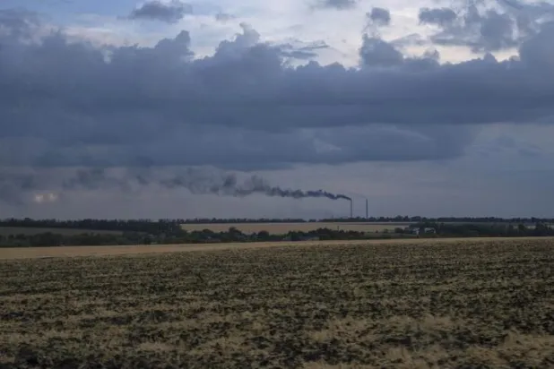 Grain fields backdropped by a power plant in Donetsk region, eastern Ukraine, Friday, July 22, 2022. (AP)