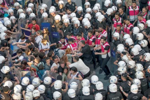 Turkish police detain demonstrators in Istanbul on the anniversary of a suicide bombing in Suruc (AFP)