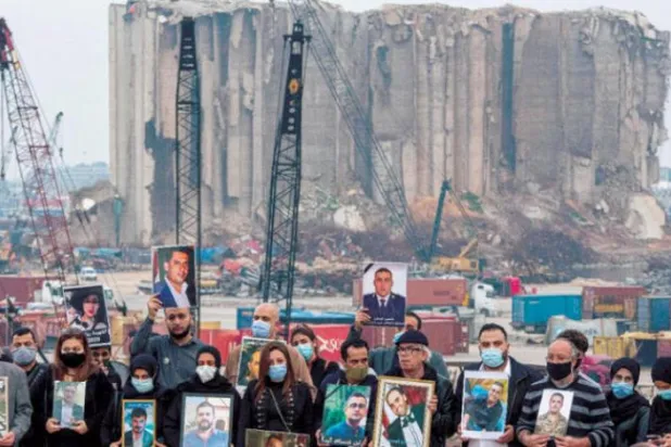  Families of several victims carry pictures of their relatives in a protest in Beirut, Lebanon (Asharq Al-Awsat)