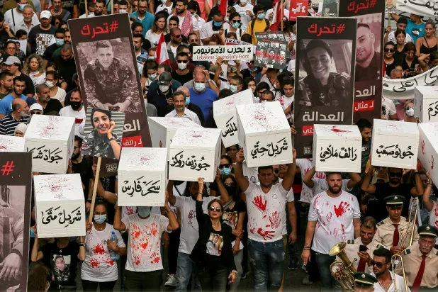 04 August 2022, Lebanon, Beirut: Families of the victims of 04 August 2020 Beirut port blast, carry symbolic coffins of their beloved ones who were killed in the devastated explosion, during a mock funeral procession to mark the 2nd anniversary of the incident. (dpa)