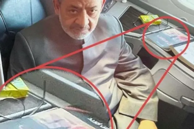 Circulated photo of Al-Azhar Sheikh with the book (Asharq Al-Awsat)