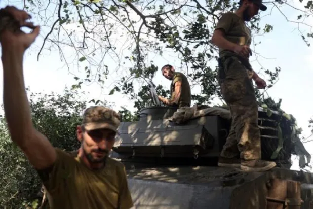 Ukraynalı askerler, Harkov’da zırhlı bir aracın tepesinde duruyor (AFP)