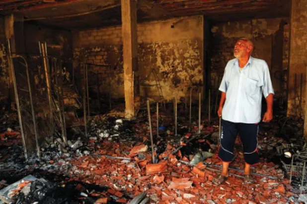 Libya’nın başkenti Trablus’taki çatışmalardan kaynaklanan zararları inceleyen bir kişi (AP)