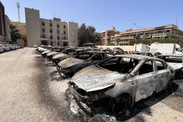 A general view over burnt ministry vehicles at the Interior Ministry after the previous day's clashes in central Tripoli, Libya, 28 August 2022. (EPA)
