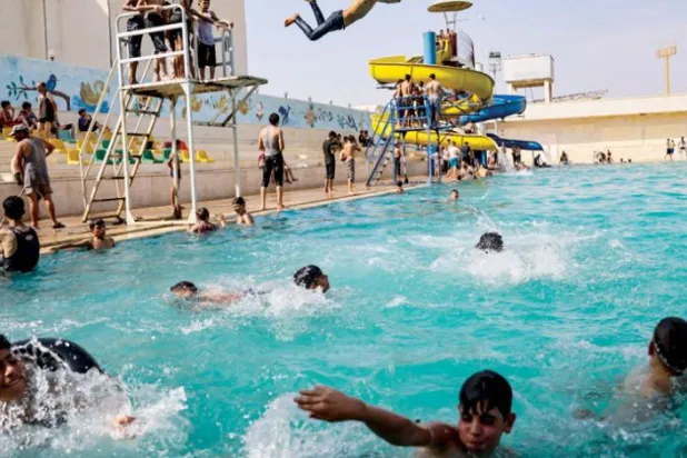  Boys swimming in a pool in Idlib governorate on Friday, while students in the regime-controlled areas prepare to return to schools this Sunday. (DPA)