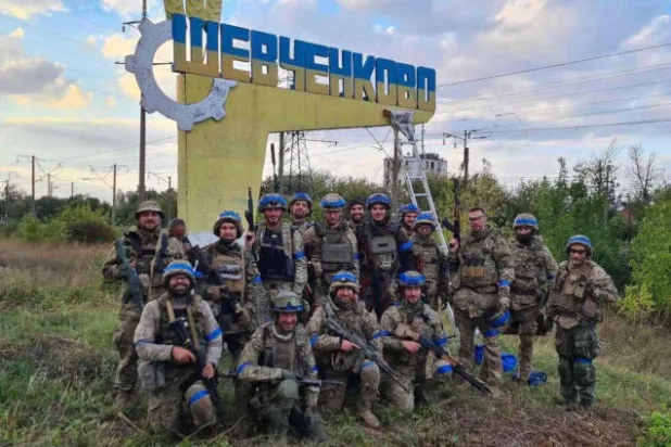 جنود أوكرانيون يحتفلون بتحرير قرية في منطقة خاركيف (رويترز)