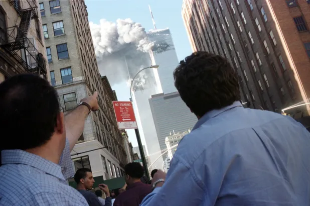 Pedestrians react to the World Trade Center collapse, September 11, 2001. (Reuters)