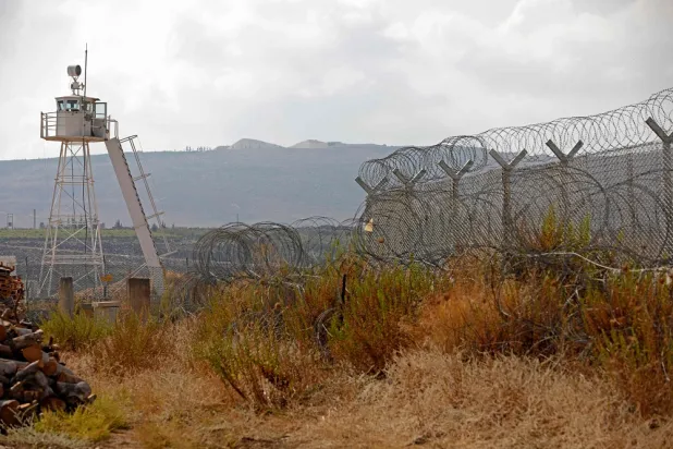 A general view shows a UN watchtower near a border fence that surrounds the divided village of Ghajar, with its northern part falling inside Lebanon and the south becoming part of the Israeli-annexed Golan Heights on September 7, 2022, as Israel lifts entry restrictions to the disputed village on the Lebanese border. (AFP)