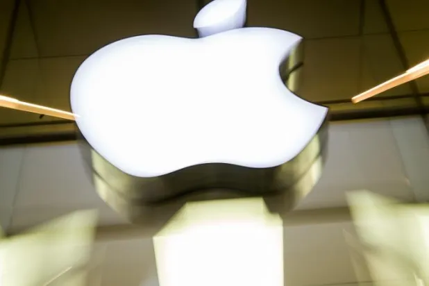 17 February 2016, Bavaria, Munich: The Apple logo shines on the façade of an Apple Store. (dpa)
