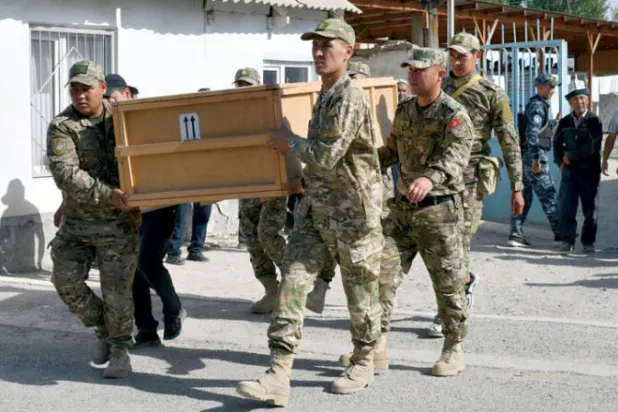 جنود في قرغيزستان يحملون نعش أحد قتلاهم أمس (أ.ب)