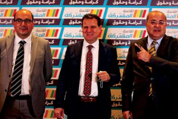 من اليسار: سامي أبو شحادة وأيمن عودة وأحمد الطيبي عند إطلاق القائمة المشتركة في فبراير 2021 (أ.ف.ب)