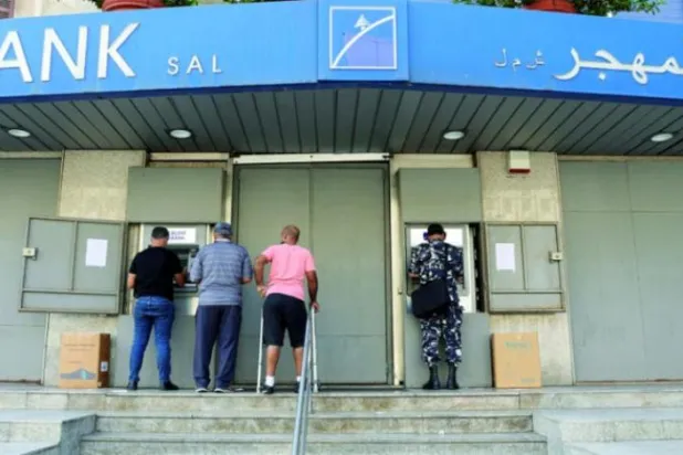 لبنانیوں کو کل بیروت میں ایک بند بینک برانچ میں خودکار ٹیلر مشینوں کے سامنے دیکھا جا سکتا ہے (رائٹرز)