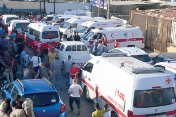 Lebanese ambulances prepare to cross to Syria to retrieve the bodies of the victims of a sinking boat (EPA)