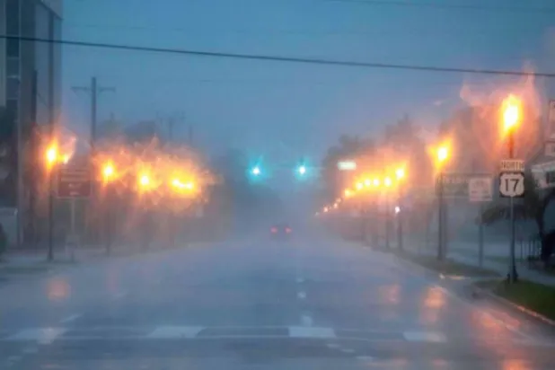 سمندری طوفان کے آنے سے پہلے ایک شخص کو فلوریڈا کے پانٹا گورڈا میں کل اپنی کار چلاتے ہوئے دیکھا جا سکتا ہے (اے ایف پی)