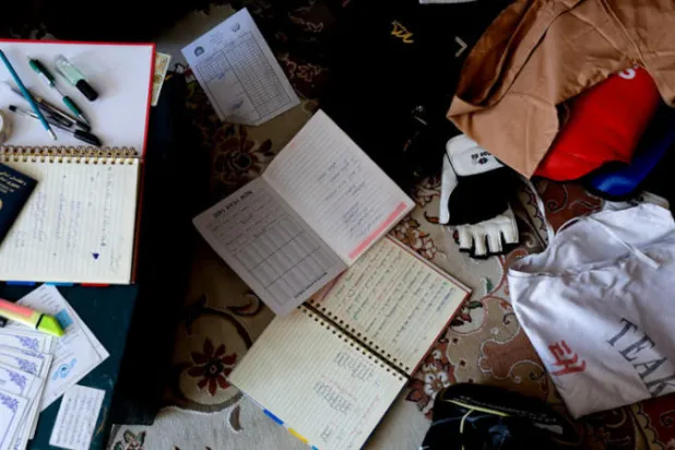 كُتب وكراسات أم البنين التي قُتلت في الهجوم الانتحاري في العاصمة كابل الجمعة (رويترز)