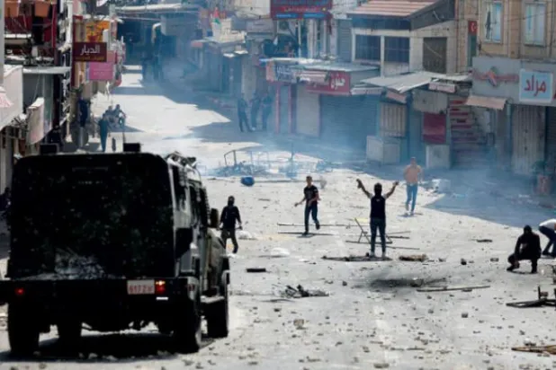 Demonstrators clash with Palestinian security forces in Nablus in the West Bank last month (Reuters)