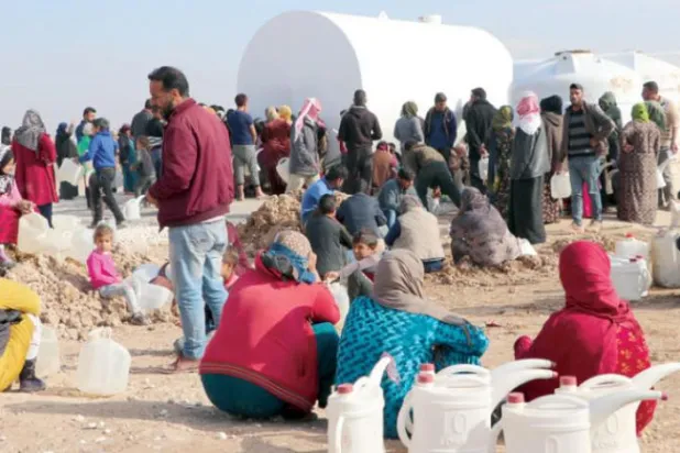 Waşokani kampında suyun doldurulmasını bekleyen göçmenler (Şarku'l Avsat)
