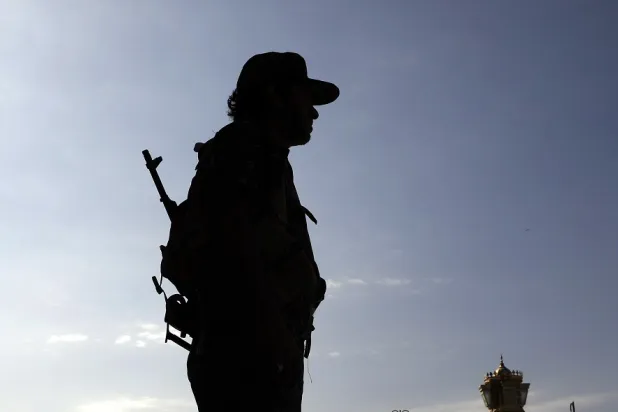 A Houthi trooper stands guard ahead of the funeral of a late Houthi official, in Sanaa, Yemen, 12 October 2022. (AFP)