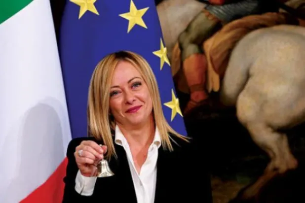  ميلوني تحمل الجرس الذي يستخدمه رئيس مجلس الوزراء لضبط المناقشات خلال الاجتماعات (أ.ف.ب) 