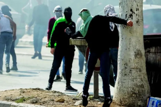 منگل کے روز نابلس میں خونریز اسرائیلی حملے کے بعد الخلیل میں مظاہرین اسرائیلی فورسز پر پتھراؤ کر رہے ہیں (رائٹرز)
