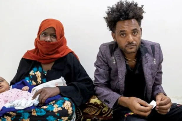 An Ethiopian migrant with his family who was flown back to his country by the International Organization for Migration from Yemen (United Nations)