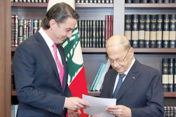 In this photo released by Lebanon's official government photographer Dalati Nohra, Lebanese President Michel Aoun, right, receives from US Envoy for Energy Affairs Amos Hochstein, the US-brokered deal setting a maritime border between Lebanon and Israel, at the presidential palace, in Beirut, Lebanon, Thursday, Oct. 27, 2022. (Dalati Nohra via AP)