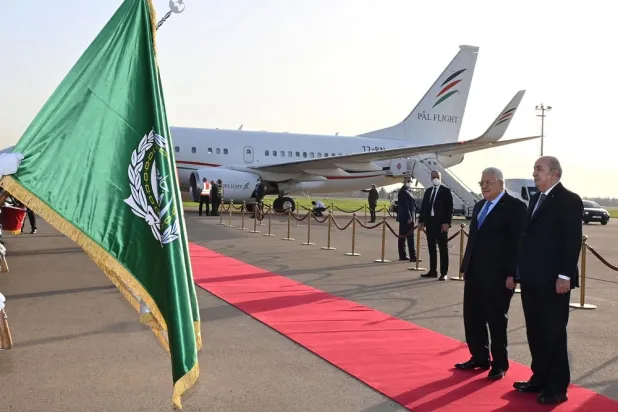 A handout photo made available by the Algerian presidency's press service shows Algerian President Abdelmadjid Tebboune (R) receiving Palestinian President Mahmoud Abbas (L) at Houari Boumediene International Airport in Algiers, Algeria, 31 October 2022. (EPA/Algerian Presidency)