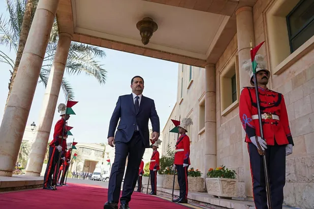 A handout picture released by Iraq's prime minister's office shows the new Prime Minister Mohamed Shia al-Sudani arriving for the official handover ceremony at the Republican Palace, the government's seat, in Baghdad's green zone. (Iraq's prime minister's office/ AFP)
