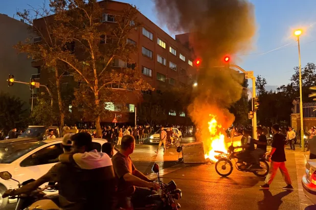 A police motorcycle burns during a protest over the death of Mahsa Amini, in Tehran, Iran September 19, 2022. WANA (West Asia News Agency) via REUTERS

 