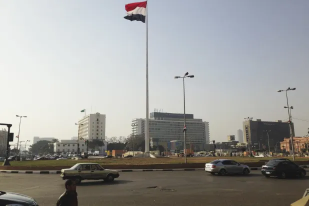 Egypt’s national flag flutters in the wind from the top of a flag pole, in Tahrir square, central Cairo, February 3, 2015. REUTERS/Asmaa Waguih
