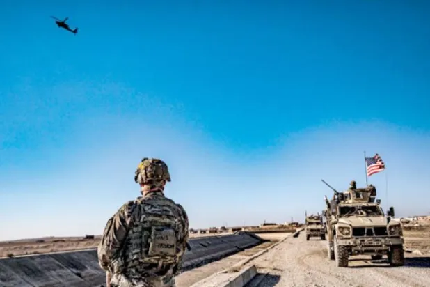 A US patrol monitors a position between the Syrian Democratic Forces (SDF) and the Syrian opposition factions supported by Türkiye in the countryside of Hasakah, east of the Euphrates, in December 2021. (AFP)