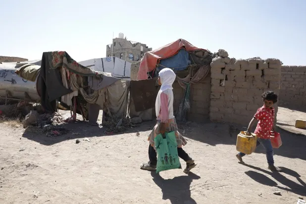 Yemeni children pass shelters at a camp for Internally Displaced Persons (IDPs) on the outskirts of Sanaa, Yemen, 05 December 2022. (EPA)