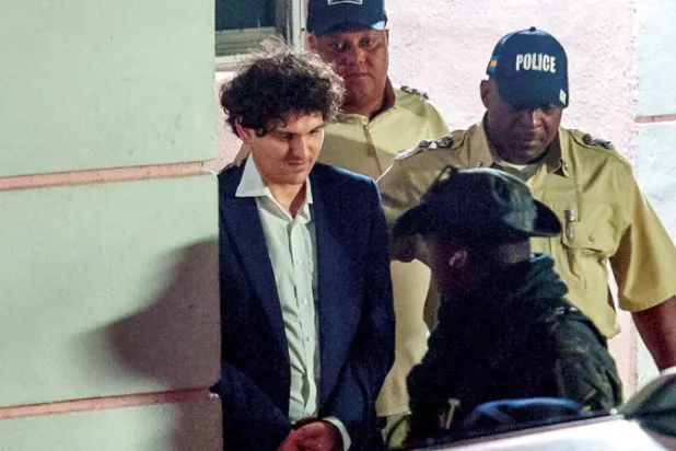 سام بانكمان - فريد في طريقه إلى محكمة في جزر البهاماس مساء الثلاثاء عقب القبض عليه (أ.ف.ب)