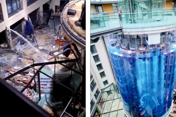 حوض السمك الذي يرتفع 12 متراً ويضم 1500 سمكة استوائية   -  الحوض بعد الانفجار في بهو فندق «راديسون بلو» (أ.ب)