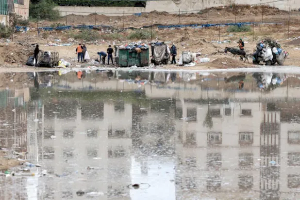 نفايات قرب بركة من المياه الملوثة في غزة نتيجة الفيضانات في نوفمبر الماضي (أ.ف.ب)