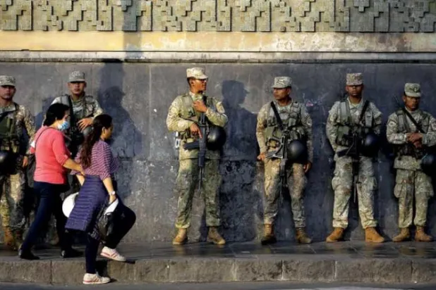 جنود يحرسون أحد الشوارع في ليما أول من أمس (إ.ب.أ)