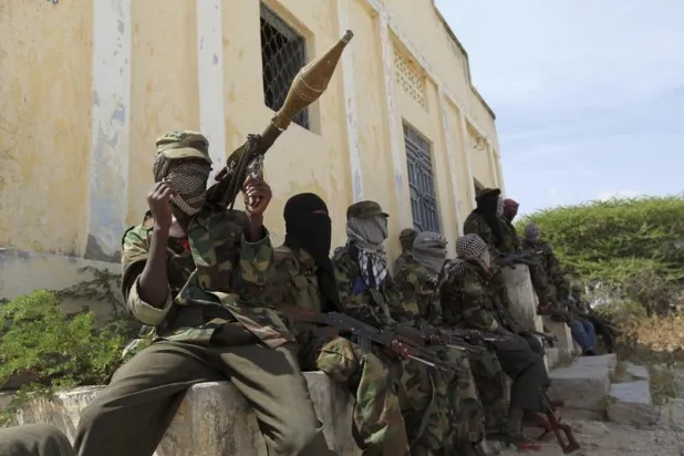 Al-Shabaab militants sit outside a building during patrol along the streets of Dayniile district in Southern Mogadishu, March 5, 2012. REUTERS/Feisal Omar 