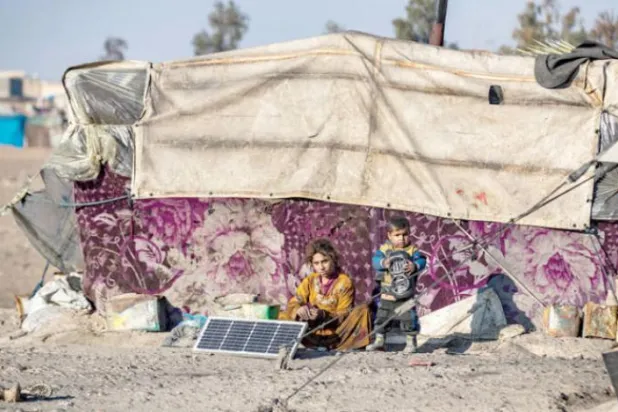 Two children in a refugee camp in the countryside of Raqqa, northern Syria (AFP)